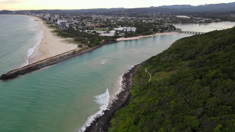 green forest at burleigh hill and the rocky groyne at burleigh beach in gold coast, australia