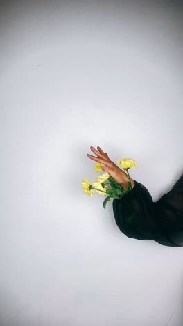 woman holding a bouquet of yellow flowers