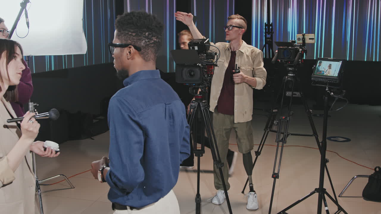 Cameraman With Prosthetic Leg And Crew Filmmaking In Studio
