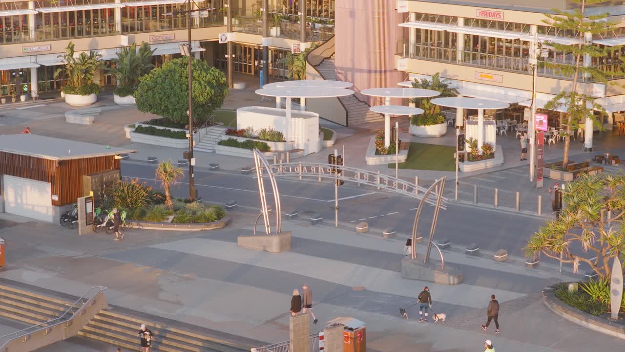 Aerial view of people walking on Surfers Paradise Boulevard during sunrise, capturing the calm morning atmosphere and urban environment
