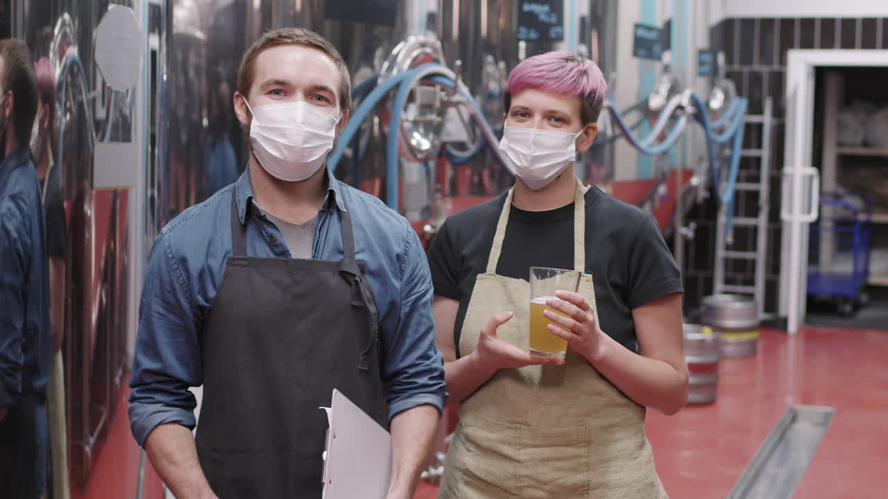 Portrait Of Brewery Workers With Freshly Made Beer