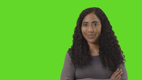 portrait of woman against green screen smiling at camera 4