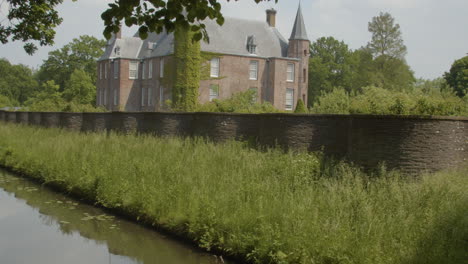 wide pan over long serpentine wall with a beautiful castle in the background