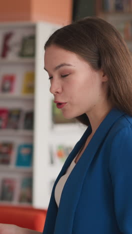 lady lecturer tells academic info in library. young woman fluent in information for lecture at university. careers in training center for young teachers