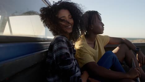 Couple-relaxing-on-a-pickup-truck-at-beach-4k