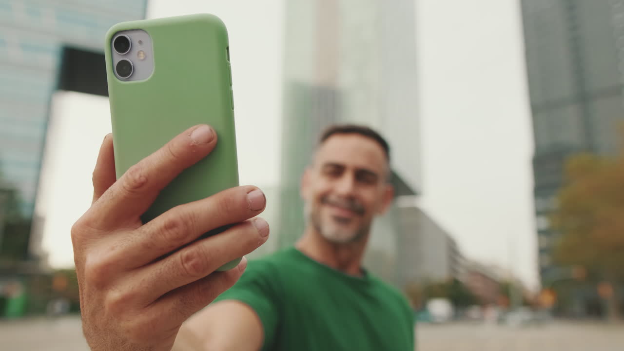 Man taking selfie with smartphone in city