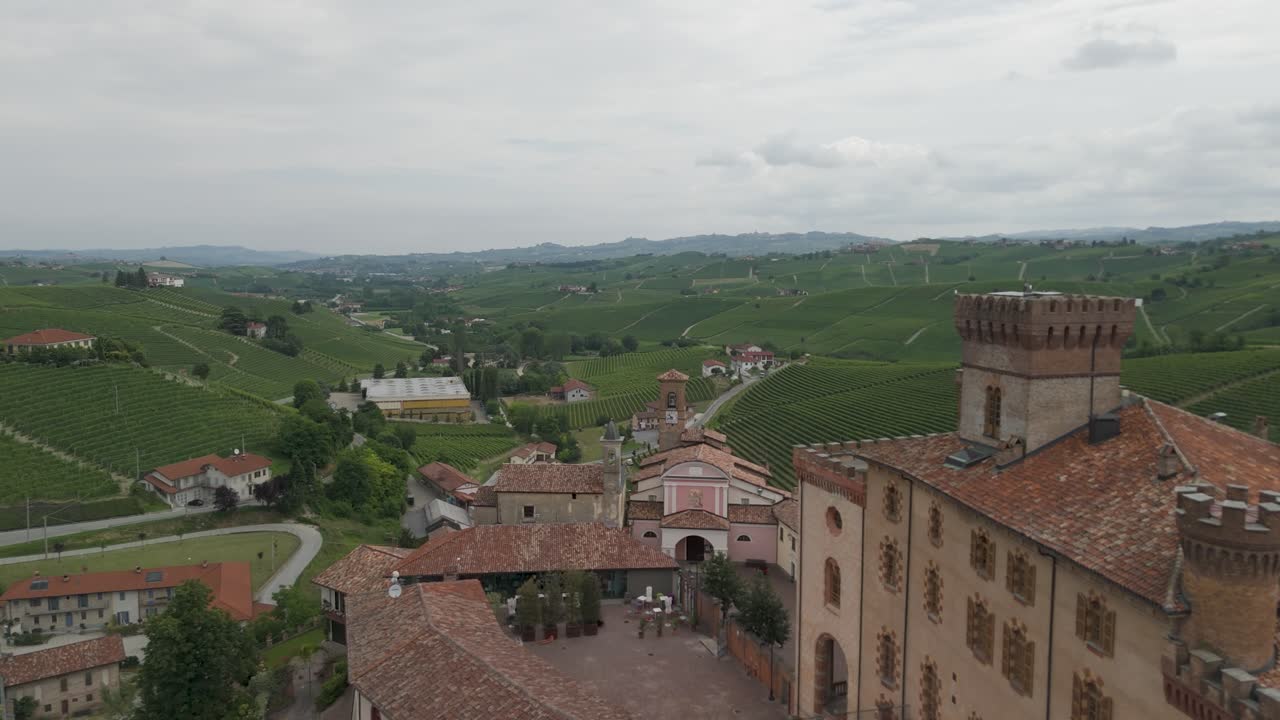 Barolo Castle in Langhe Wine Region, Cuneo, Piedmont, Italy. 4K Aerial view of the village and the vineyards, flying forward, close to the castle.