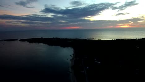 Cinematic-aerial-footage-of-a-white-sand-beach-in-a-tropical-island-in-the-Philippines-taken-during-a-sunset