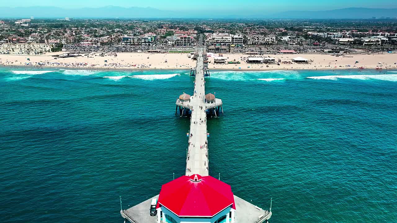 캘리포니아 헌팅턴 비치의 부두 위의 공중 전망과 주변을 돌아다니는 몇몇 사람들과 태평양과 해변과 서핑의 시원한 전망