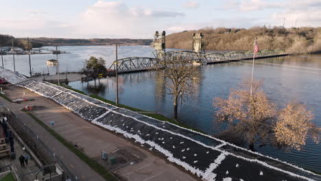 massive sandbag barrier and pumps preventing flooded river from submerging city under water during spring