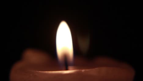 rotating candle in the dark, close-up