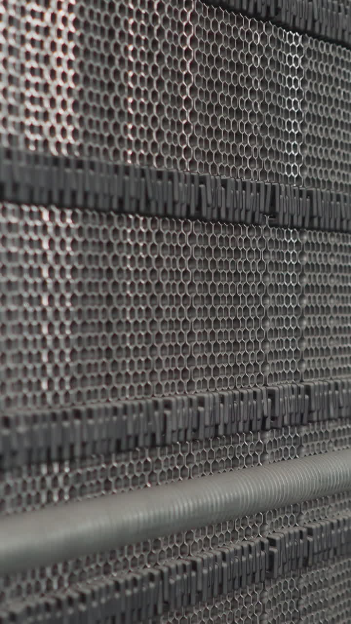 Machine tool with perforated surface against pipes with thermal insulation in mechanical room closeup. Heating system parts in modern boiler room
