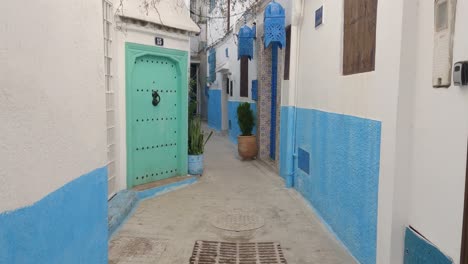 Walk-POV-through-colorful-alleyway-in-Tangier-medina,-Morocco