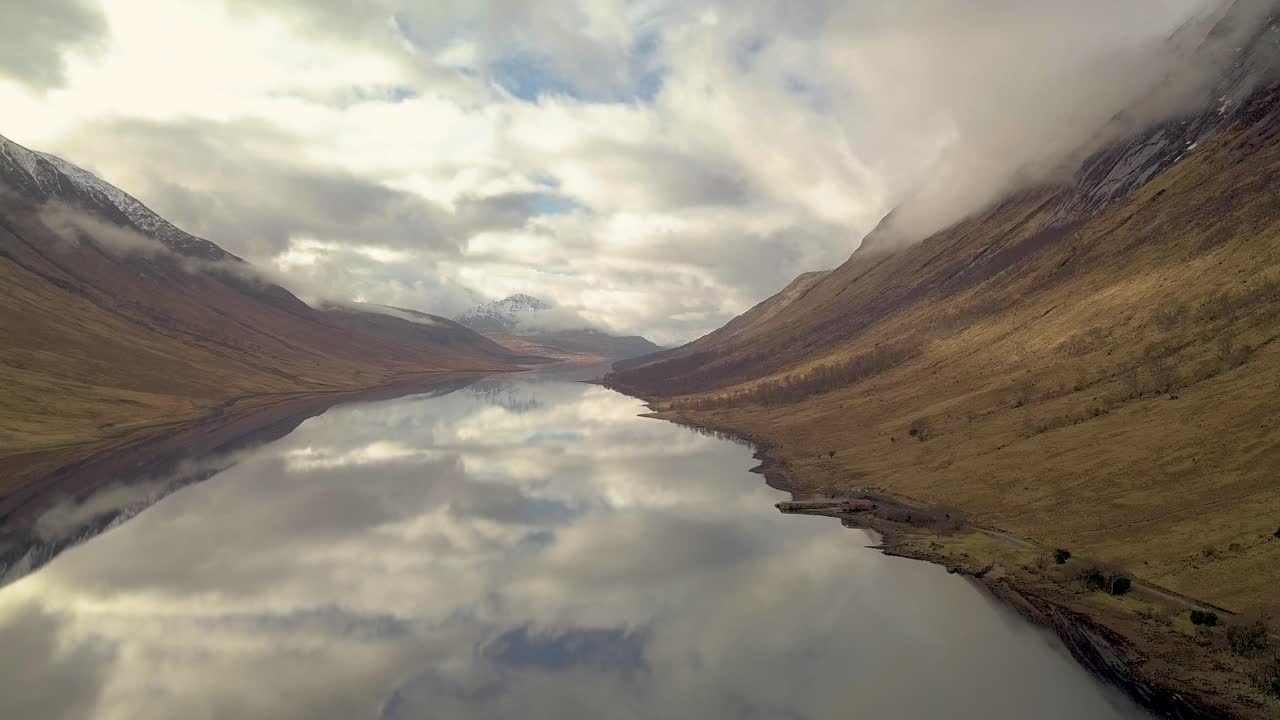 Aerial panorama view of Glen Etive highlands with lake and reflection on water surface in Scotland