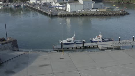 fishing boats tied to pier in sunny dunmore east fisheries harbour