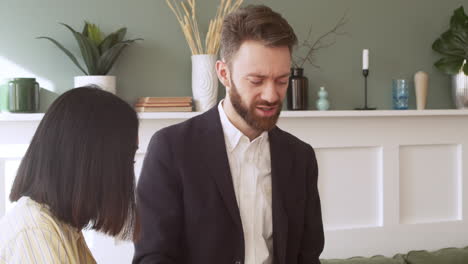 man and woman talking together and debating during a team meeting