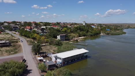 zipline drone shot of a quiet fishing village in by the danube river delta, located in tulcea county, in northern dobruja, in romania