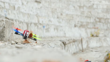 racing drone maneuvers dangerously near a concrete wall