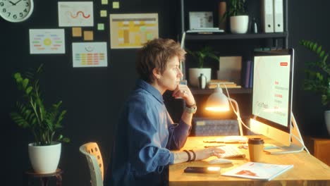 businesswoman analyzing chart and working on computer in office