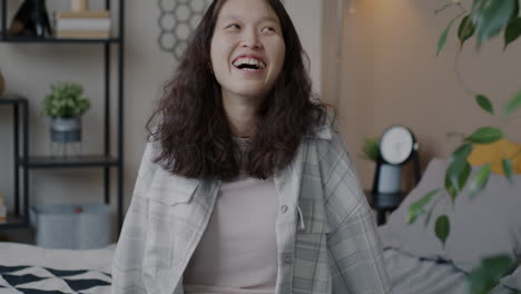 happy young woman in bedroom