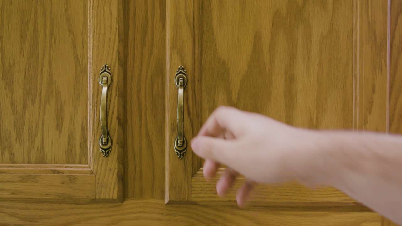 Man Puts Plate Into Cupboard