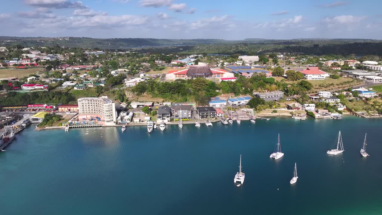 Yachts On Waterfront Of Port Vila In Vanuatu With National Convention Center In View. aerial shot