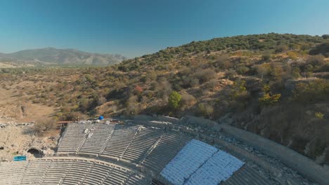 flying above old theater in ancient roman city of ephesus, turkey, historic landmark on sunny day