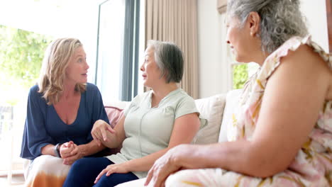 senior diverse group of women share a conversation at home