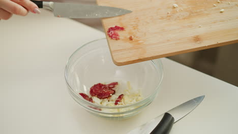 preparing a salad with eggs and sausage