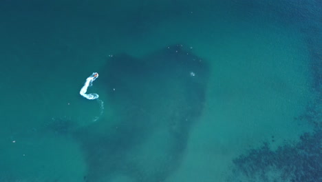aerial shot of a jet ski over the sea