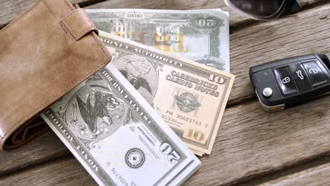 Wallet,-currency-and-car-key-on-table-4k