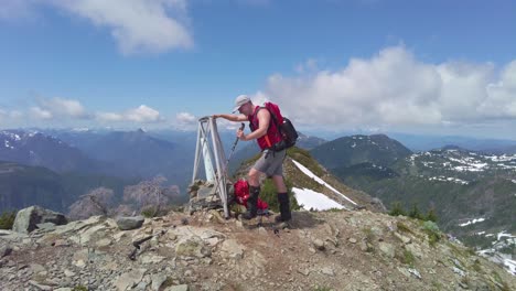 man reaching the mountain summit, mount 5040, vancouver island, canada