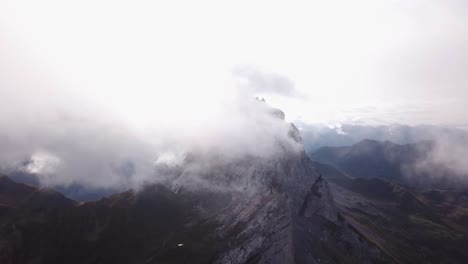 drone flight by clouds alps in austria vorarlberg over reservoir lake