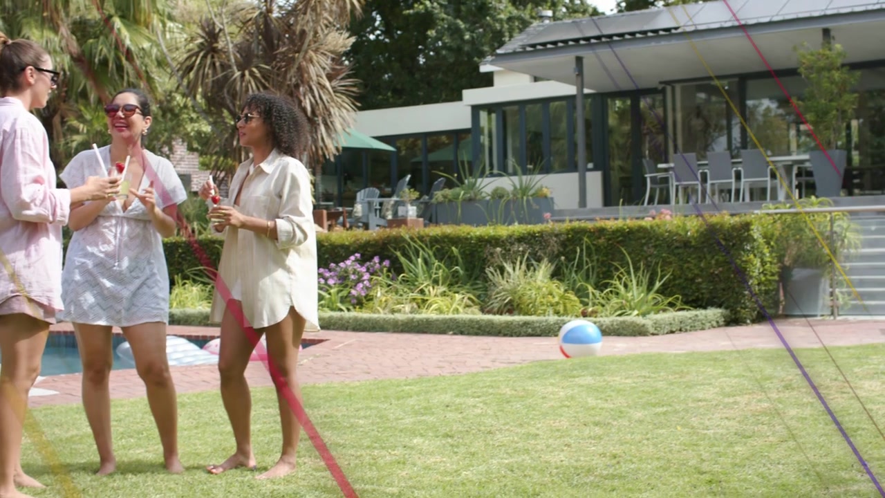 Three women chatting when one lifting drink, for leisure on pool lawn, diagonal streaks hiding view