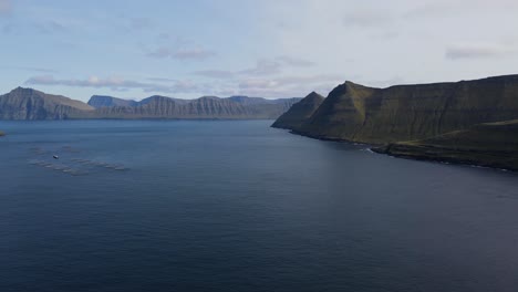 Drohnenaufnahmen-Von-Fjorden-Und-Bergen-Mit-Lachskulturen-Und-Einem-Dorf-Auf-Der-Insel-Eysturoy-Auf-Den-Färöer-Inseln