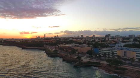 aerial circling over santo domingo waterfront malecon at sunset in dominican republic