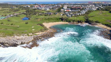 little bay beach with rock ledges and the eastern suburbs in south-eastern sydney, australia