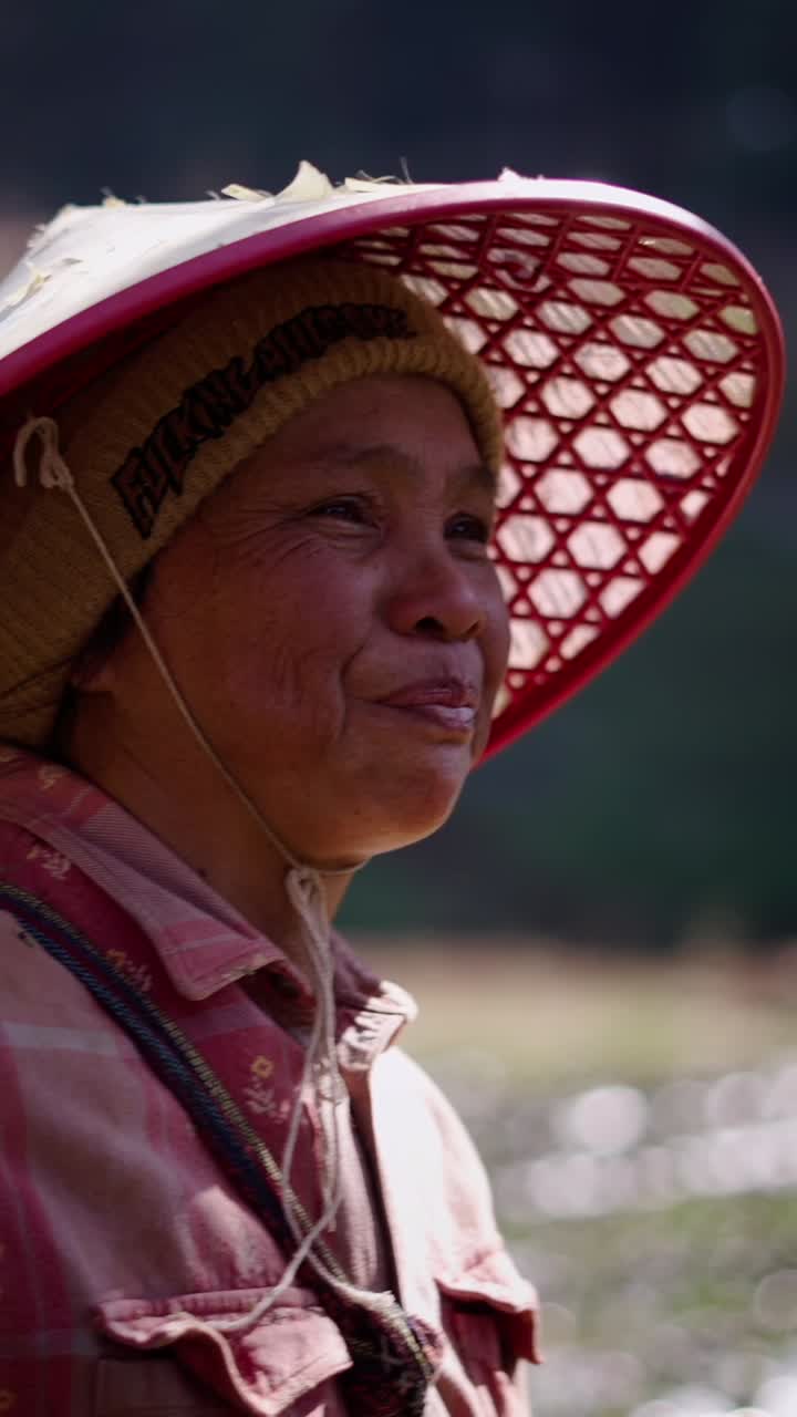 Portrait of a woman wearing an Asian conical hat