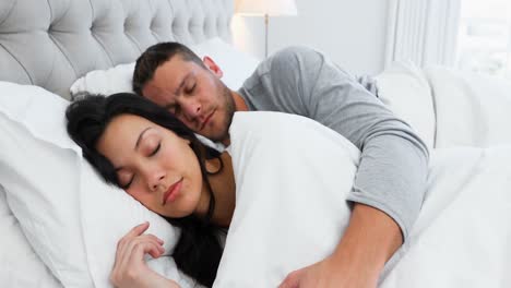 Couple-sleeping-peacefully-on-bed-4k