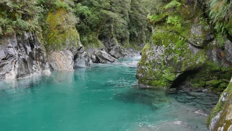 deep clear river pool below upstream ripples reveals sculpted rock