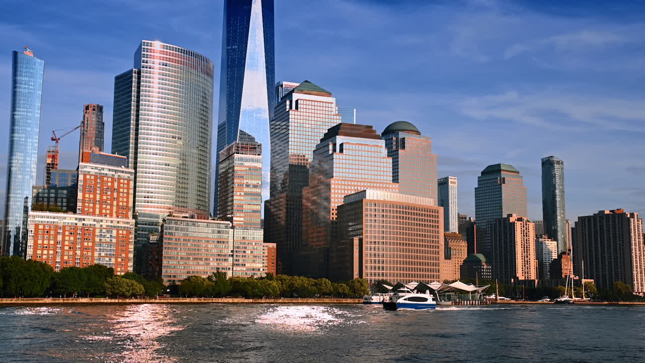 Fantastic buildings at the waterfront of the river. Boat moves along the riverside. River tour by New York, USA
