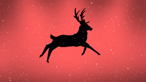 Snow-falling-over-silhouette-of-reindeer-running-against-orange-background