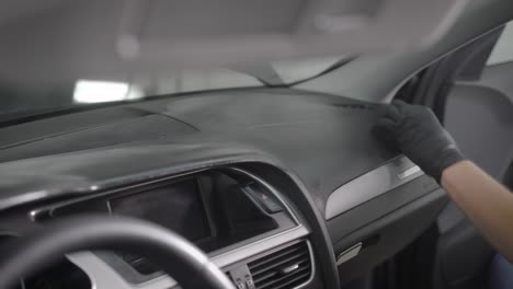 faceless worker wiping car panel with rag