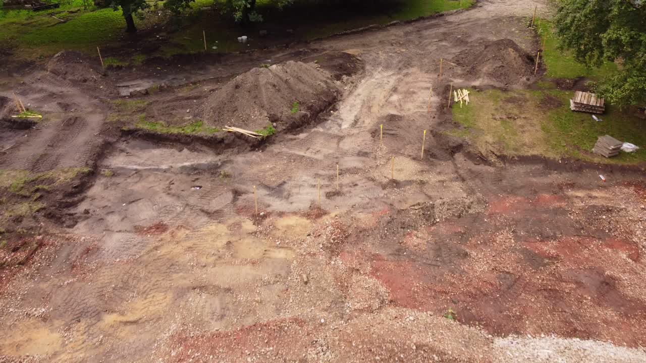 Dirty ground with gravel pile for parking lot construction, aerial view