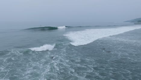 Aerial-Drone-view-of-Surfers-at-Sunrise-La-Bocana-El-Tunco-El-Salvador