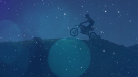 motorcyclist riding on hill during snowfall animation