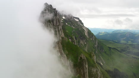 cinematic drone shot flying through the clouds at altenalp turm