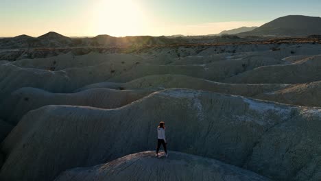 tourist standing on uneven terrain in desert