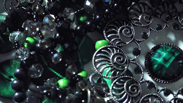 jewelry, beads. close-up. rotation. Beautiful shiny, sparkling jewelry with glare in gems. Macro. A lot of beads in different colors. various jewelry, stone products, green malachite beads