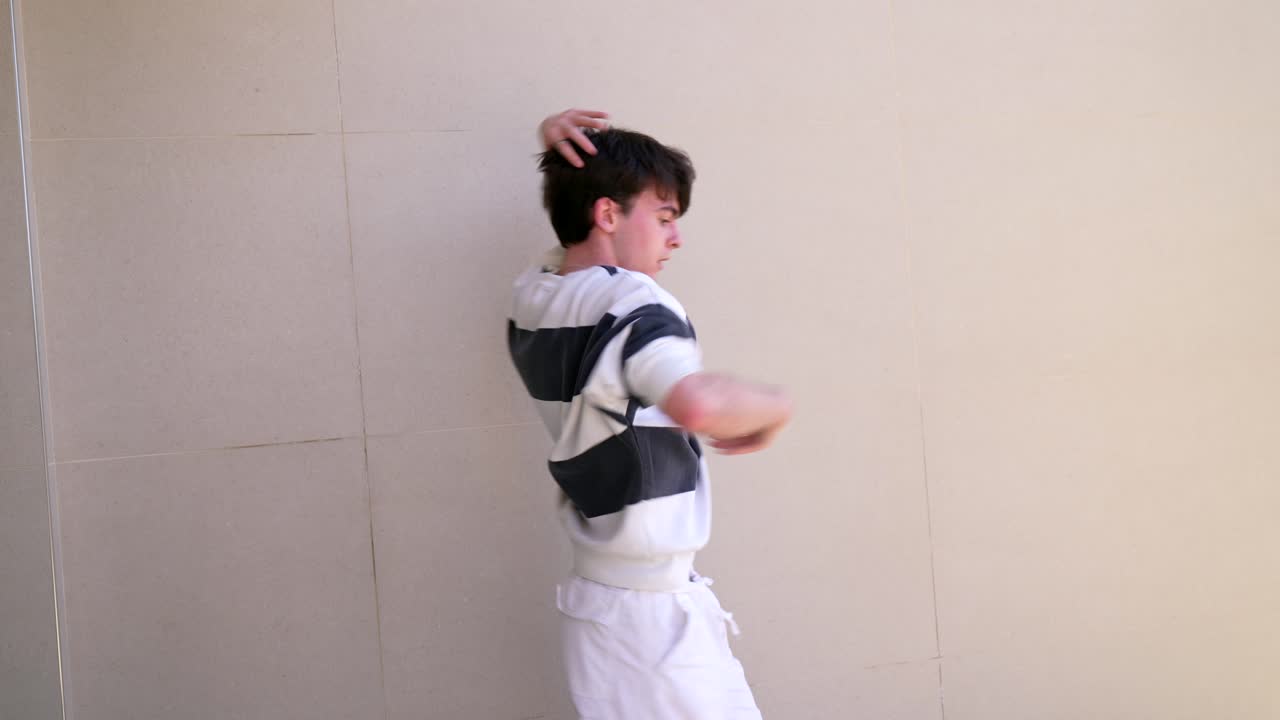 Man dancing in front of a wall